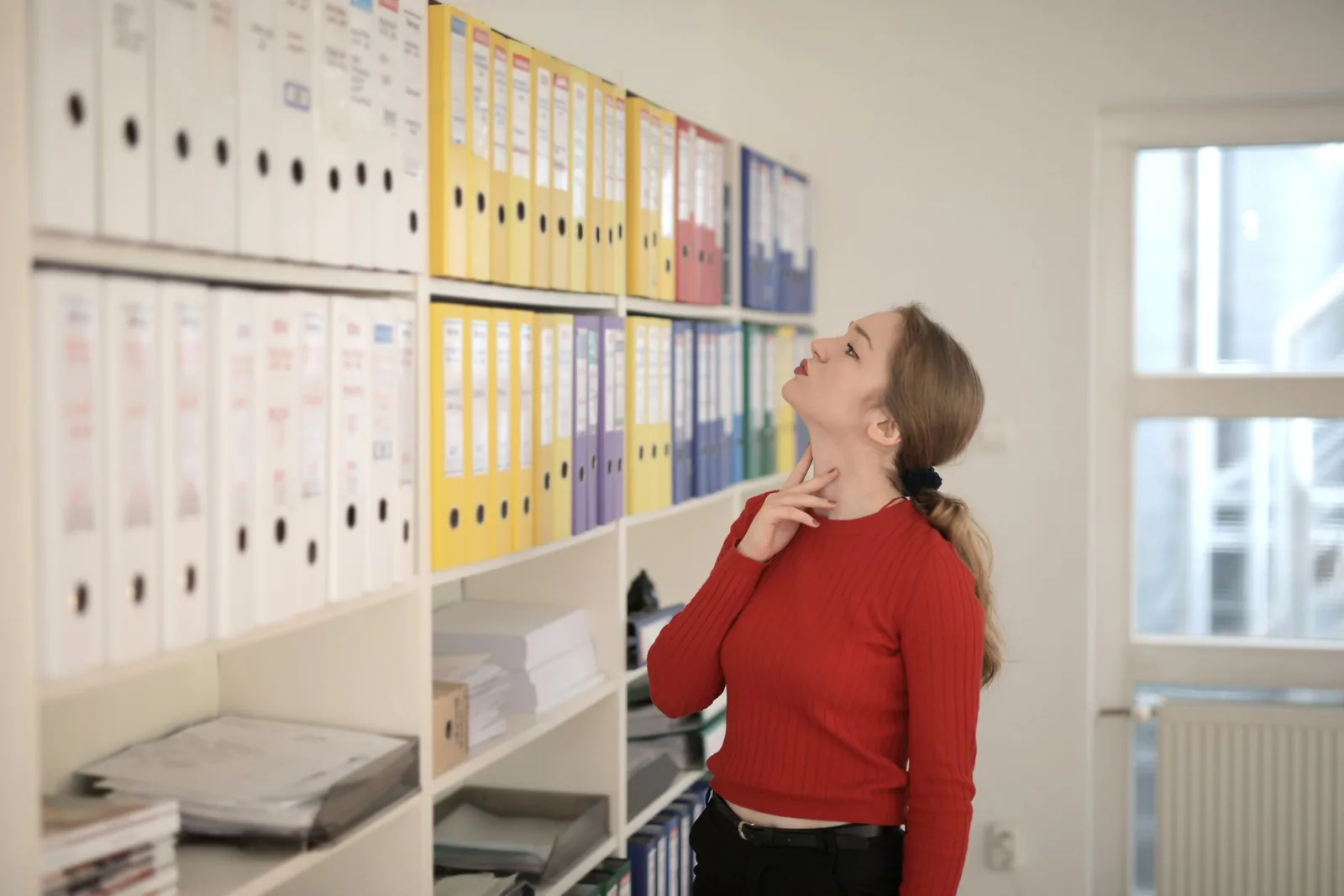 Professional browsing folders in an office archive.